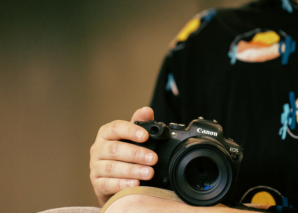 Image of hand holding a Canon digital camera